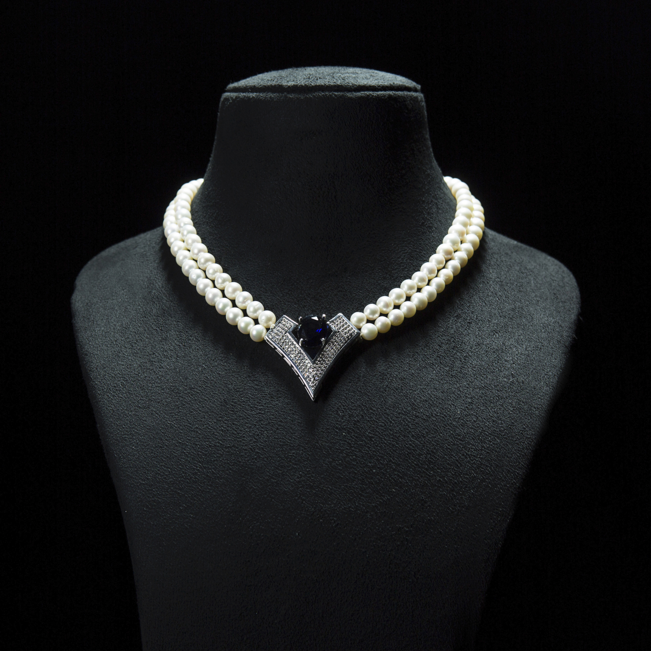 Classic diamond  and blue sapphire stone studded Vendetta white pearl double stranded necklace- with silver floral clasp