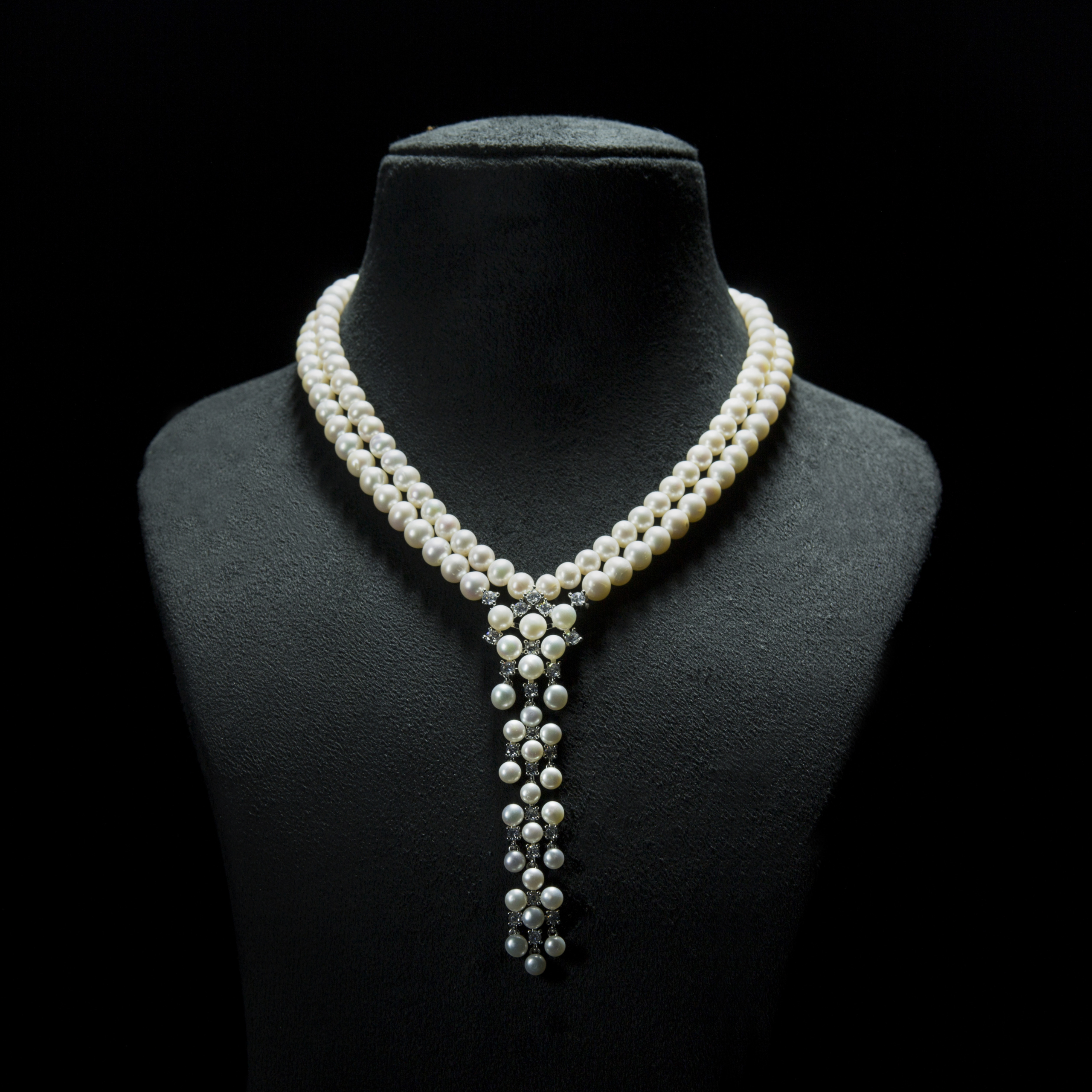 Classic pearl and diamond studded double stranded white pearl necklace- with silver floral clasp