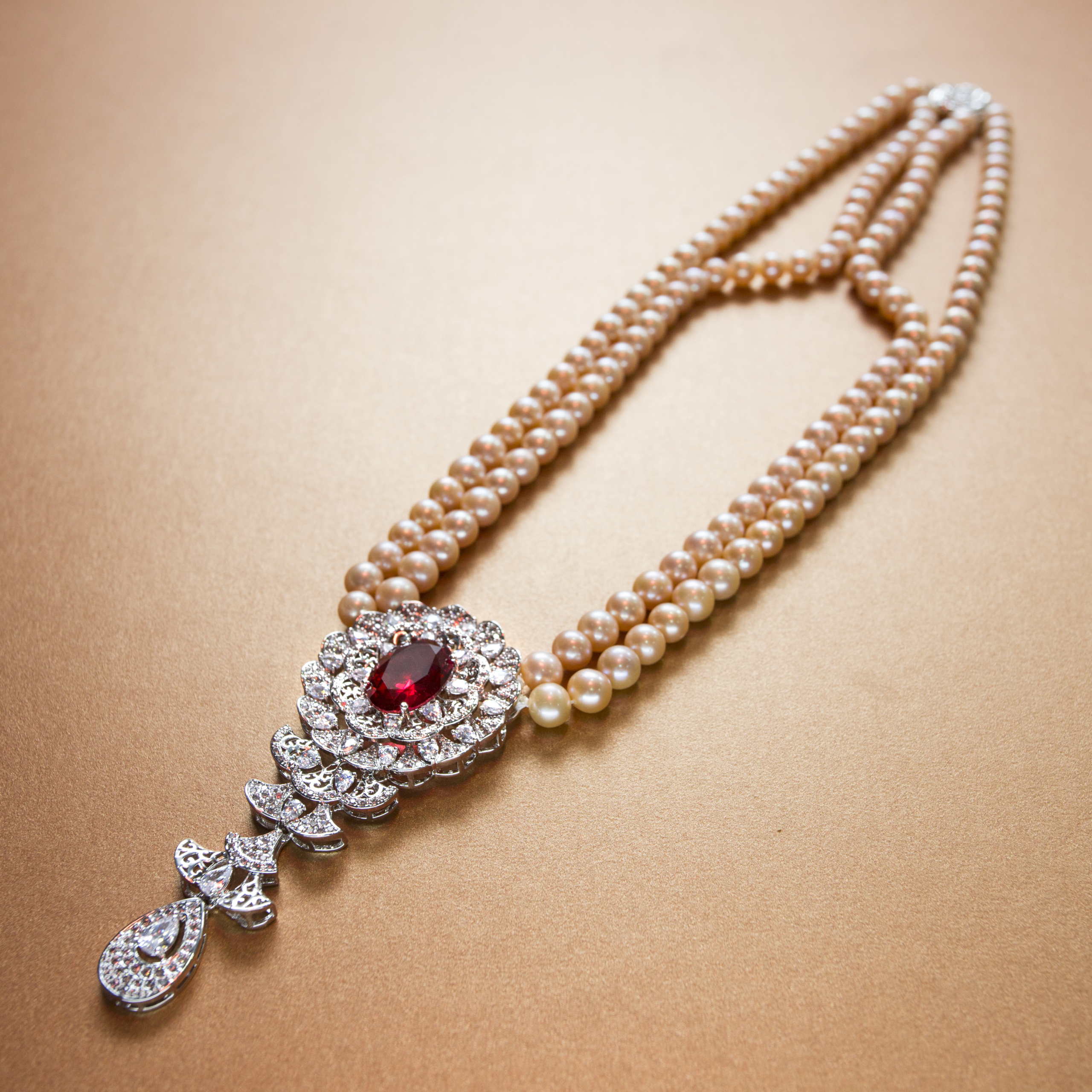 Classic floral diamond and single pink ruby stone studded  pink pearl necklace- with floral silver clasp